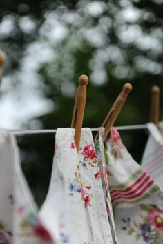 clothes hanging on a line outside with trees in the background