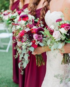 the bride and her bridesmaids are holding bouquets in their hands at this outdoor wedding