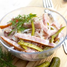 a glass bowl filled with meat and vegetables