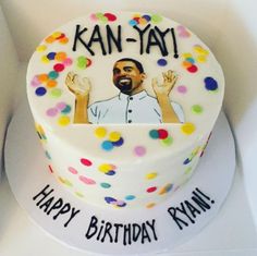 a birthday cake decorated with an image of a man waving his hands and confetti on top