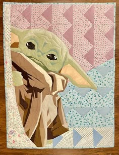 the baby yoda is depicted in this handmade quilted wallhanging pattern