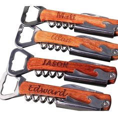 four personalized wine openers with wooden handles and corkscrews on them