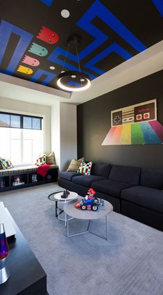 a living room filled with furniture and a colorful ceiling