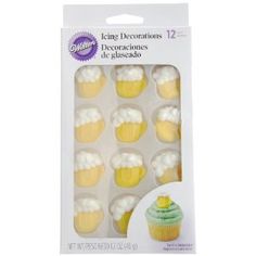 cupcakes with white frosting and yellow icing are in a package on a white background