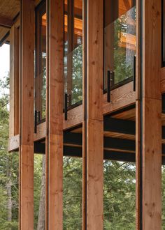 the inside of a wooden building with windows and wood sidings on each side of it