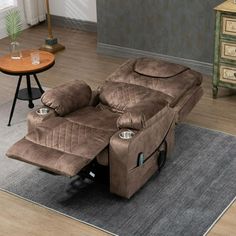 a living room with a brown recliner on the floor and a table next to it