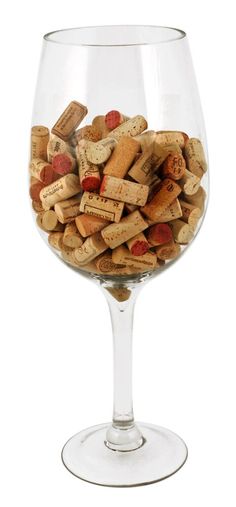 a glass filled with lots of wine corks