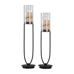 two black metal and glass candle holders with candles on each end, one is turned upside down