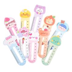 several children's rulers with cartoon animals on them, all in different colors and sizes