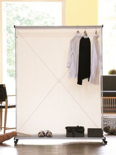 an open white board with clothes hanging on it