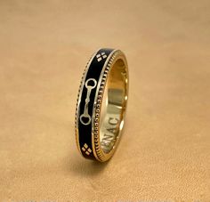 A slim stackable version of our Equus Enamel Ring. Beautiful combination of black enamel and 18 karat yellow gold. 4mm wide Equus (Latin for horse) Cheval (French for horse), stars and a snaffle bit in a continual pattern. Fine beaded detail on both edges. Absolutely gorgeous stacked with the Slim Lace Rein & Diamond Stack rings! Create your own combination! Hand made in the US Made to order, please allow 4-6 weeks for delivery. Formal Yellow Gold Enamel Ring With Black Details, Formal Yellow Gold Ring With Black Enamel, Formal Yellow Gold Black Enamel Ring, Luxury Gold Enamel Ring, Luxury Black Enamel Ring, Designer Black Enamel Rings For Gift, Luxury Yellow Gold Rings With Black Enamel, Luxury Enamel Ring, Luxury 14k Gold Black Enamel Ring