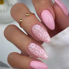 a manicure with pink and white polka dots on the tip, gold ring at the top