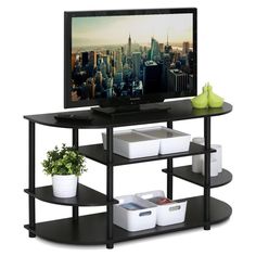 a flat screen tv sitting on top of a black shelf