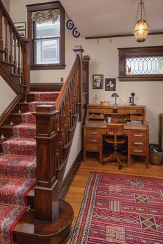 the stairs in this home are made of wood and have red carpeting on them