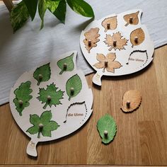 two wooden cutouts with leaves on them