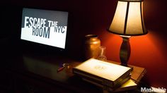 a desk with a lamp and a sign on it