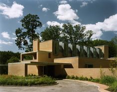 a large building with lots of windows on top of it's sides and trees in the background