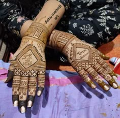 two hands with henna designs on them