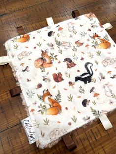 an image of a table cloth on the floor with squirrels and acorns