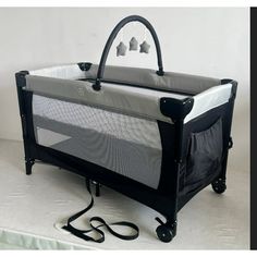 a baby crib with an infant's bed attached to it