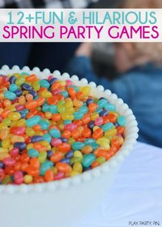 a white bowl filled with colorful candy sprinkles on top of a table