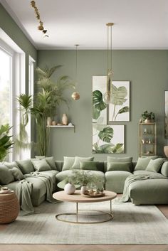 a living room filled with lots of green furniture and paintings on the wall above it