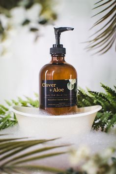 a bottle of soap sitting on top of a bowl