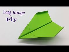 a green origami plane with the words long range fly on it's side