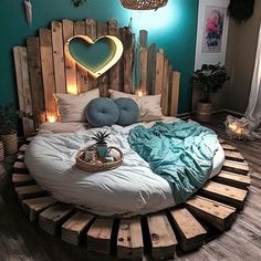 a bed made out of wooden pallets with lights on the headboard and pillows