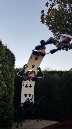 an art piece is in the shape of a man riding a skateboard