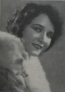 an old black and white photo of a woman with a fur coat on her shoulders