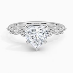 a white gold engagement ring with a heart shaped diamond