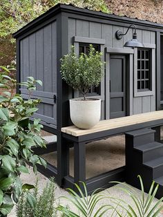 an outdoor bench with potted plants on it