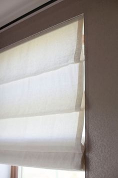 the blinds in this room are closed and ready to be hung up by the window