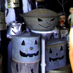 there are many metal buckets with faces on them