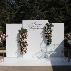 an outdoor ceremony setup with flowers and greenery