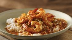 a white bowl filled with shrimp and rice