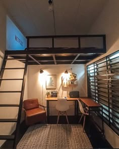 a loft bed with a desk underneath it and two brown chairs in front of it