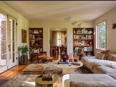 a living room filled with furniture and bookshelves