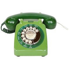 an old fashioned green rotary telephone on a white background