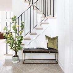 an image of a person walking down the stairs on their cell phone in front of a staircase