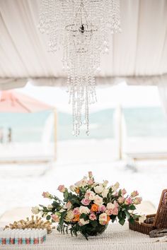 a table topped with a vase filled with flowers