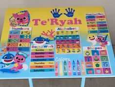 a children's table with a colorful poster on it