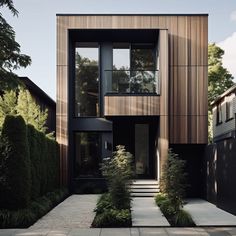 a modern house with wood siding and stone walkway leading up to the front door area