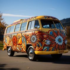 an orange and yellow van with flowers painted on it