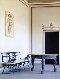 two benches and a table in an empty room