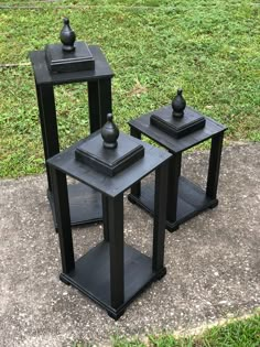 two black tables sitting on top of a cement slab