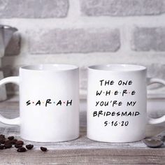 two white coffee mugs with the words, the one where you're my bridesmaid