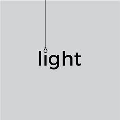 the word light is hanging from a wire on a gray background with black letters that spell out