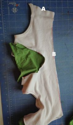 the baby's bodysuit is being cut out and sewn